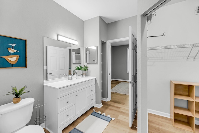 60 Fenwick Hall Aly Unit 415, Johns Island, SC 29455 - bathroom with vanity, toilet, wood finished floors, and baseboards