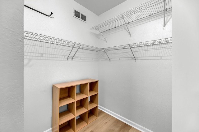 60 Fenwick Hall Aly Unit 415, Johns Island, SC 29455 - walk in closet featuring wood finished floors