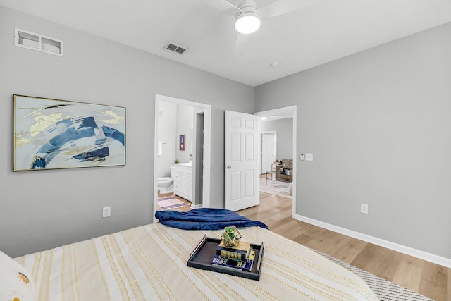 60 Fenwick Hall Aly Unit 415, Johns Island, SC 29455 - bedroom featuring light wood-style floors, baseboards, ensuite bath, and a ceiling fan