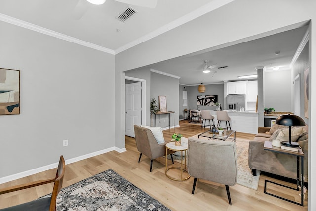 60 Fenwick Hall Aly Unit 415, Johns Island, SC 29455 - living area featuring ceiling fan, crown molding, light wood finished floors, and baseboards