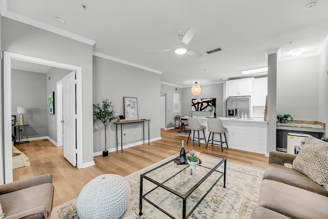 60 Fenwick Hall Aly Unit 415, Johns Island, SC 29455 - living room with light wood-type flooring, crown molding, a ceiling fan, and baseboards