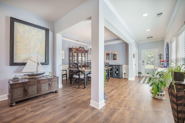 hall featuring wood finished floors, ornamental molding, baseboards, and recessed lighting