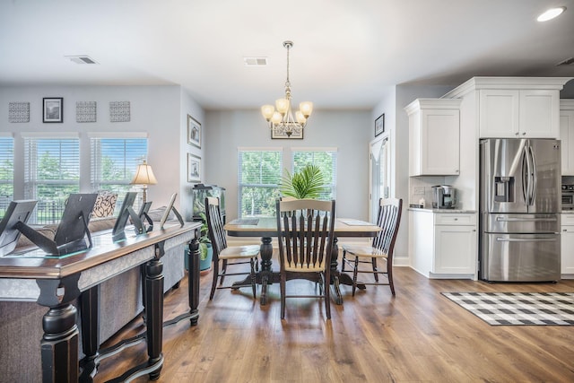 dining area with a chandelier, light wood finished floors, recessed lighting, and baseboards