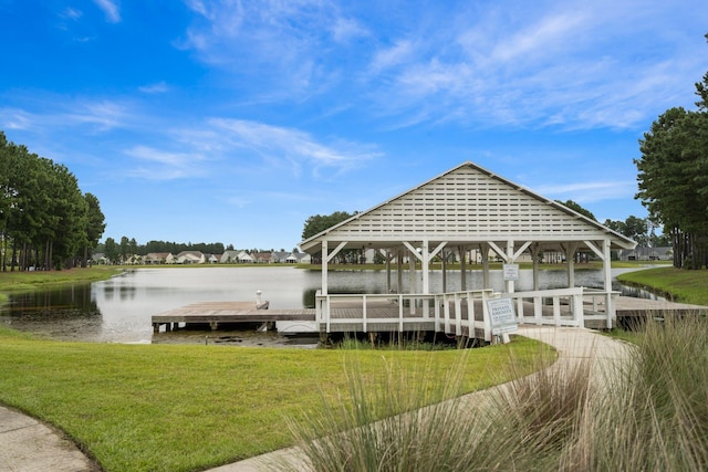 dock area featuring a water view, a lawn, and a gazebo