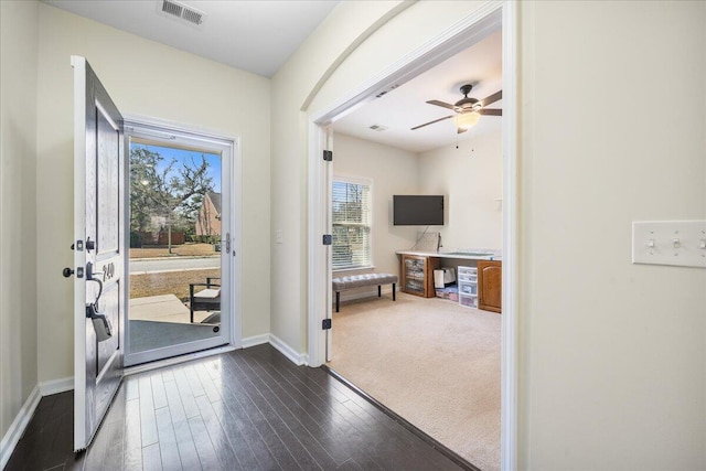 entryway featuring dark wood-style floors, visible vents, ceiling fan, and baseboards