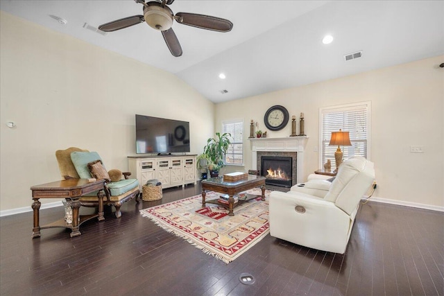 living room with visible vents, vaulted ceiling, baseboards, and wood finished floors