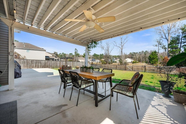 view of patio / terrace featuring a fenced backyard, a ceiling fan, and outdoor dining space