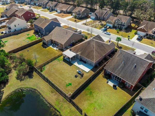 bird's eye view featuring a residential view and a water view