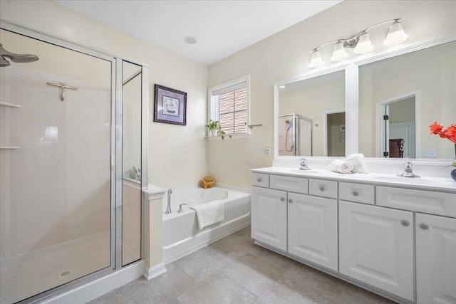 bathroom featuring a sink, a shower stall, double vanity, and a bath