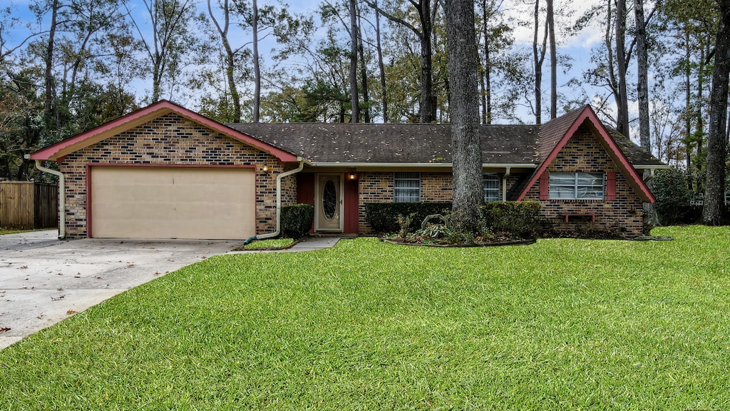 ranch-style house featuring a garage and a front yard