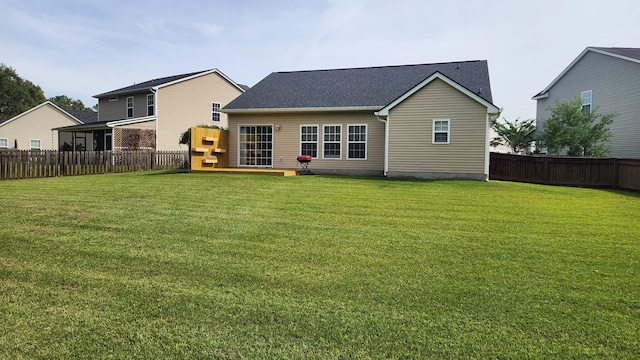 back of property with a lawn