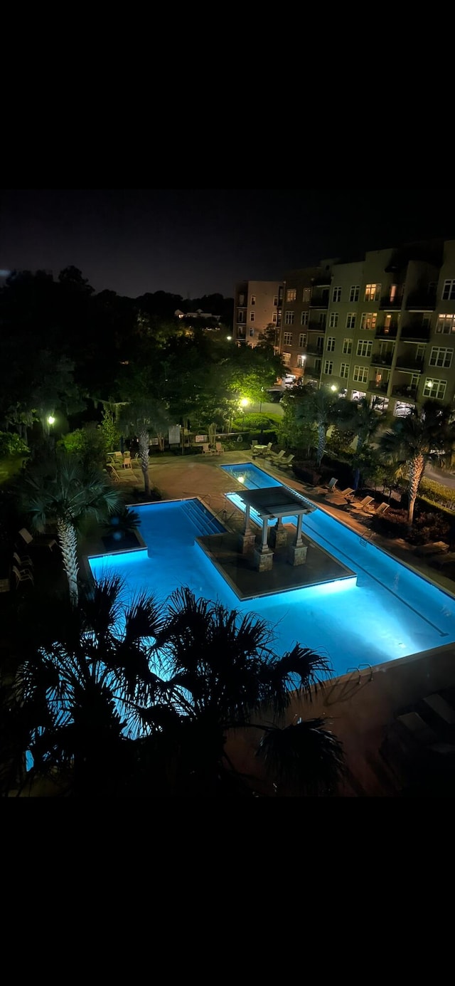 view of pool at twilight