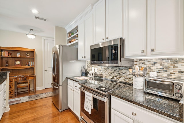 kitchen featuring a toaster, open shelves, visible vents, appliances with stainless steel finishes, and white cabinets