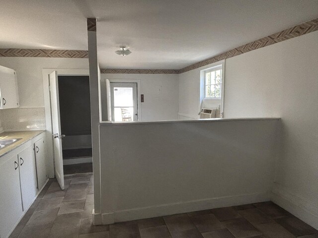 1907 Helm Ave, North Charleston, SC 29405 - kitchen with light countertops, white cabinets, cooling unit, and baseboards