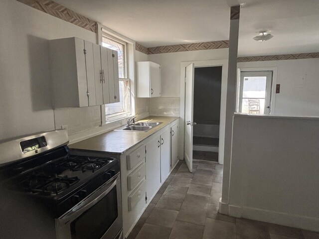 1907 Helm Ave, North Charleston, SC 29405 - kitchen with a sink, plenty of natural light, stainless steel range with gas stovetop, and white cabinets