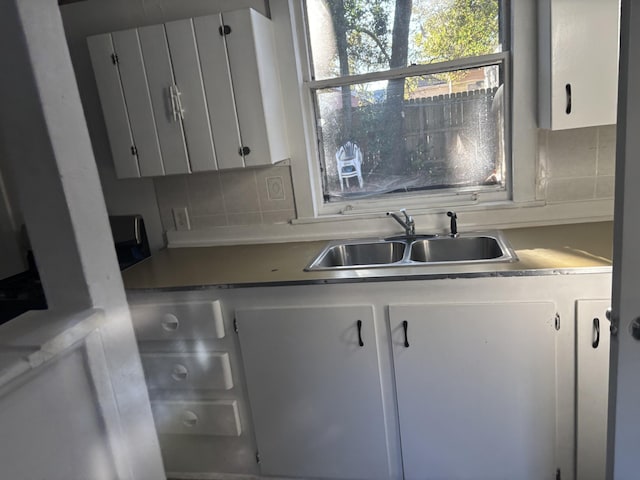 1907 Helm Ave, North Charleston, SC 29405 - kitchen with tasteful backsplash, white cabinetry, and a sink