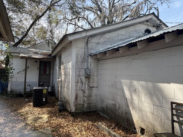 1907 Helm Ave, North Charleston, SC 29405 - view of property exterior with central air condition unit, concrete block siding, and metal roof