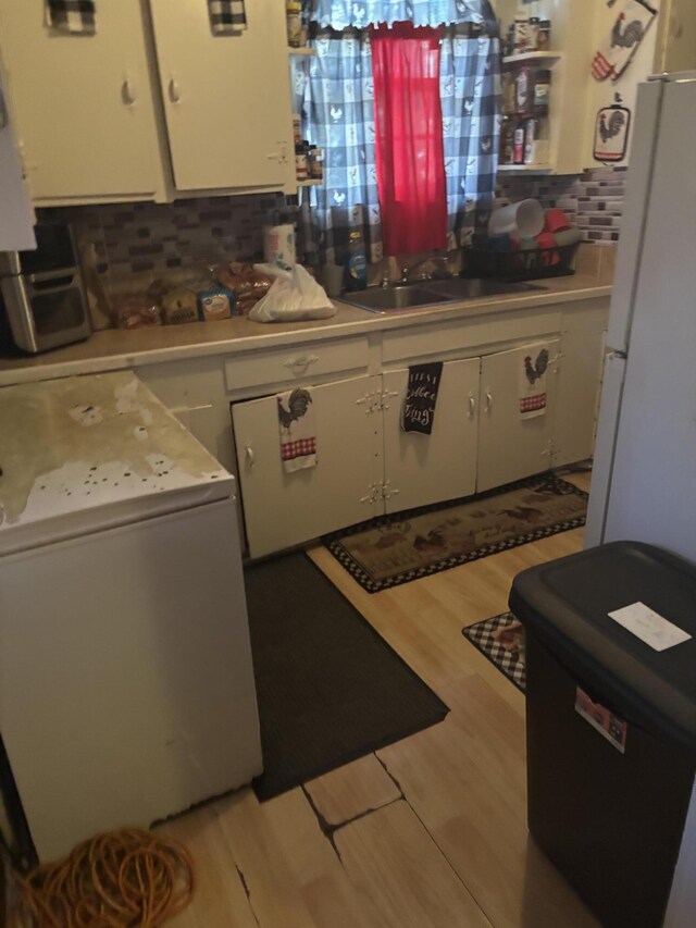 1907 Helm Ave, North Charleston, SC 29405 - kitchen with light wood-style floors, white cabinets, light countertops, and freestanding refrigerator