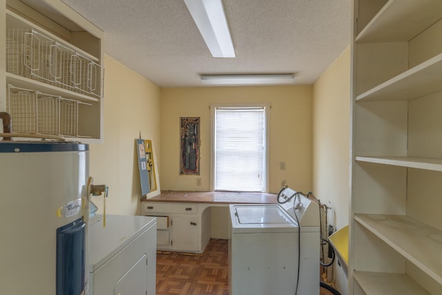 laundry room with laundry area, water heater, a textured ceiling, and washing machine and clothes dryer