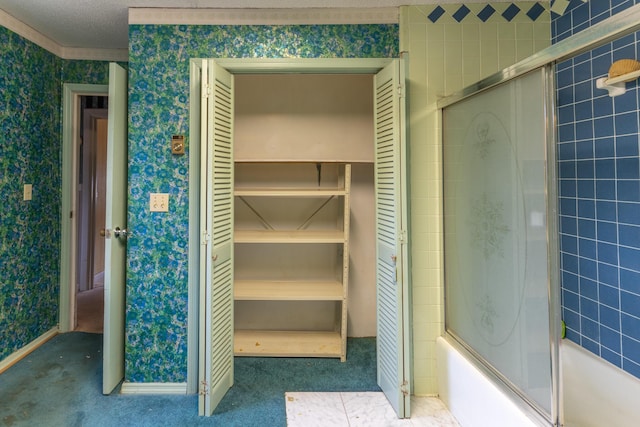 full bathroom with wallpapered walls, baseboards, bath / shower combo with glass door, and a textured ceiling