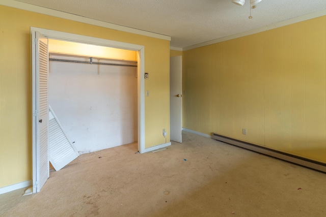 unfurnished bedroom featuring a textured ceiling, light carpet, ornamental molding, baseboard heating, and a closet