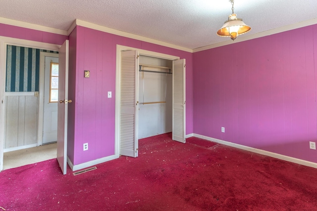 unfurnished bedroom with carpet, a closet, visible vents, and a textured ceiling