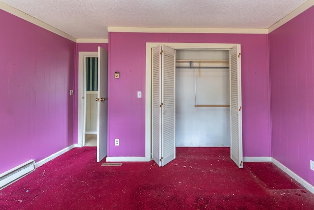 unfurnished bedroom featuring a baseboard heating unit, a closet, dark carpet, and a textured ceiling