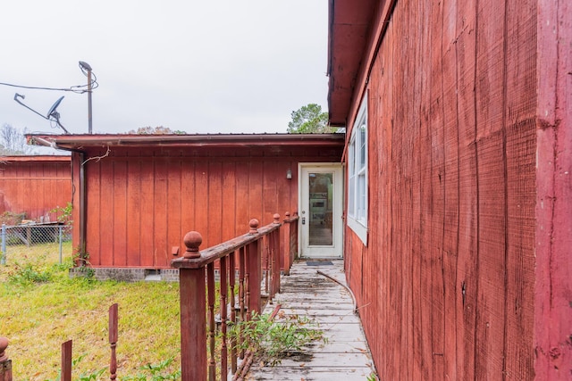 property entrance featuring crawl space and fence