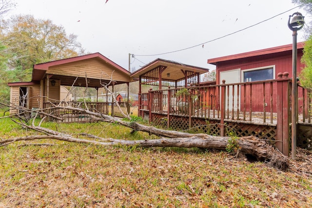 rear view of property featuring a deck