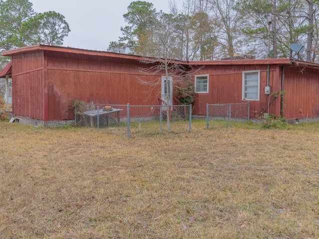 view of property exterior featuring crawl space, fence, and a lawn