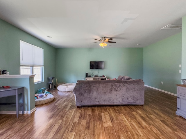 living room with hardwood / wood-style flooring and ceiling fan