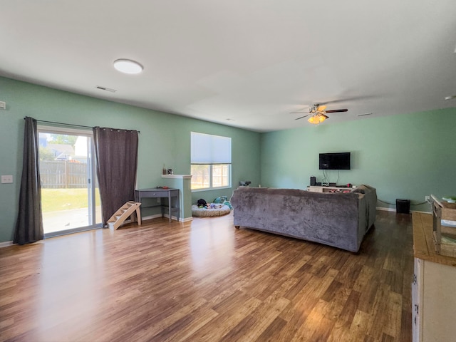 living room with a healthy amount of sunlight, hardwood / wood-style flooring, and ceiling fan