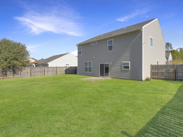 rear view of property with a patio area and a lawn