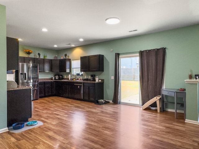 kitchen with sink, stainless steel fridge, dark brown cabinetry, and light hardwood / wood-style floors