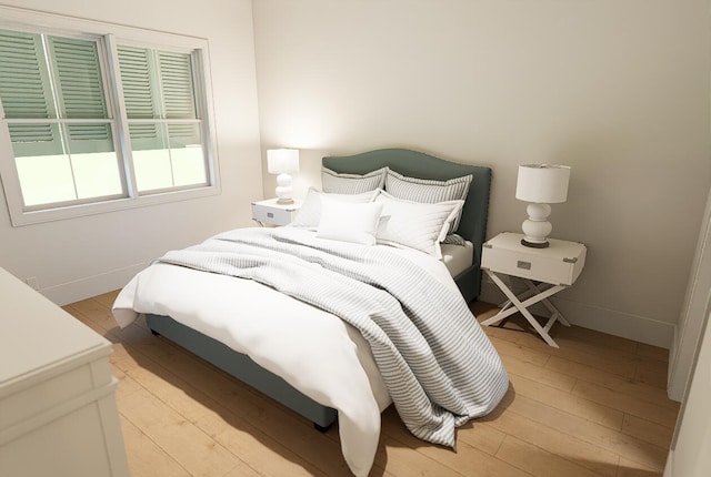bedroom featuring light wood-style floors and baseboards