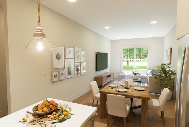 dining room with light wood-style flooring and recessed lighting