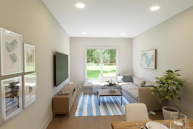 living area featuring recessed lighting, baseboards, and wood finished floors