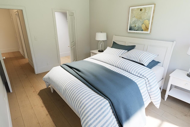 bedroom featuring baseboards and light wood-style floors