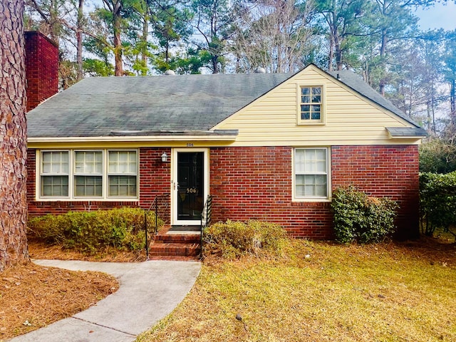 bungalow-style home featuring a front lawn