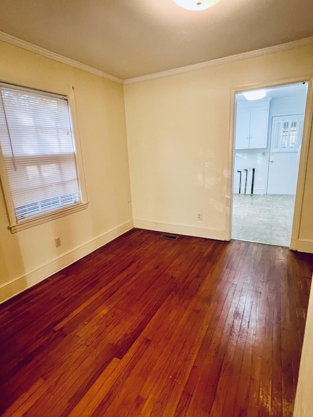 spare room with hardwood / wood-style flooring and ornamental molding