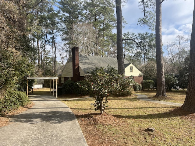 view of property exterior featuring a carport and a lawn