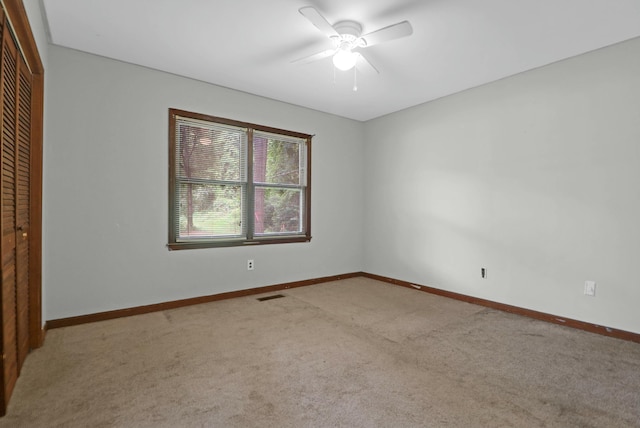 empty room featuring ceiling fan and carpet flooring