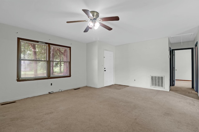 unfurnished room with ceiling fan and light colored carpet