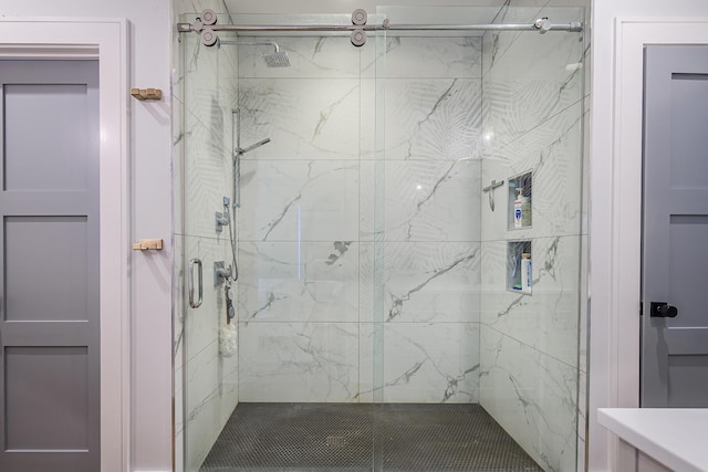 bathroom featuring a marble finish shower