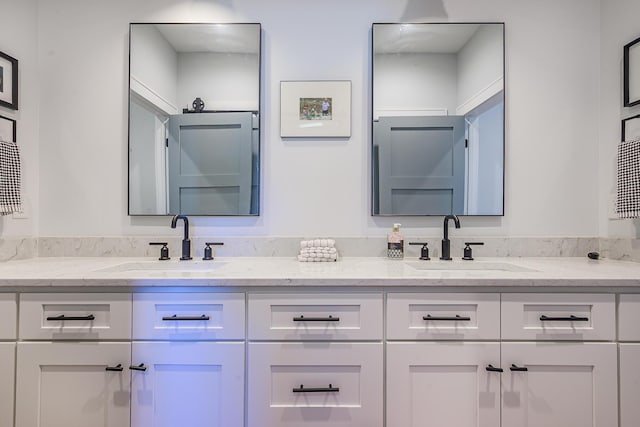 bathroom featuring double vanity and a sink