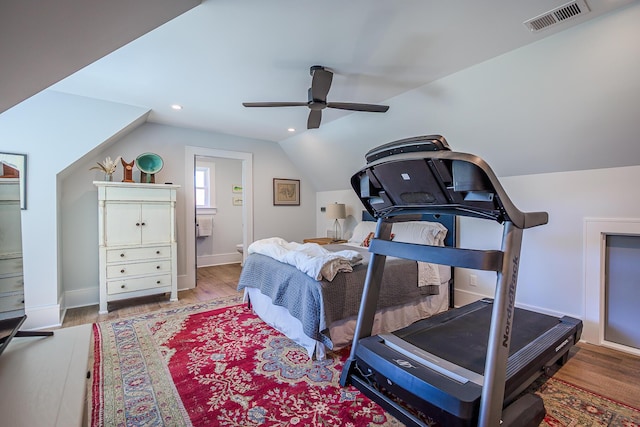 exercise area with visible vents, lofted ceiling, a ceiling fan, and wood finished floors