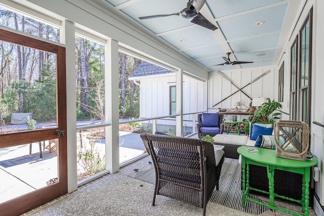 sunroom / solarium featuring coffered ceiling and a ceiling fan