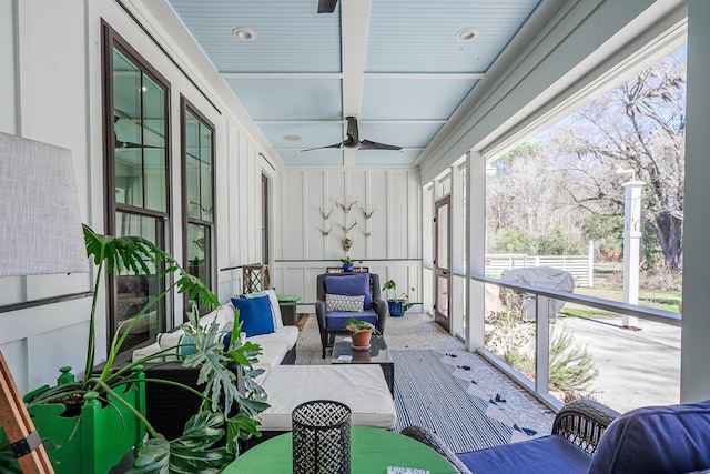 sunroom with coffered ceiling and ceiling fan