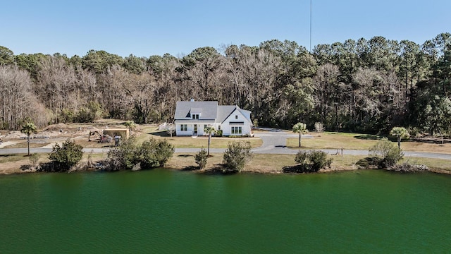 drone / aerial view with a water view and a view of trees