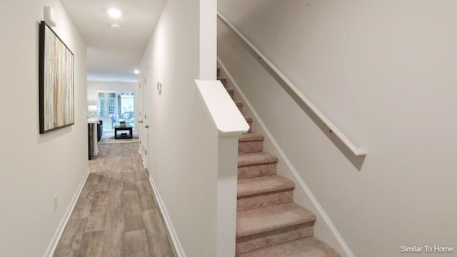 stairway featuring wood-type flooring